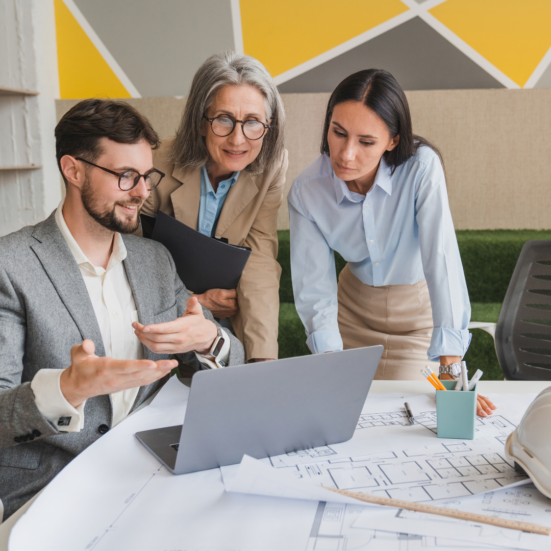 Facilities management professionals meeting over property blueprints